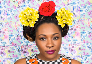 Photo of a woman with yellow and red flowers in her hair
