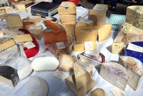 Array of cheeses on a market stall