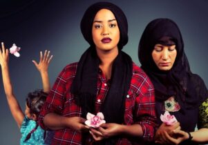 Three women hold flowers in their hands