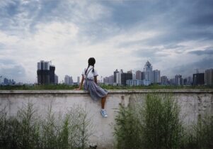 A woman sitting on a wall