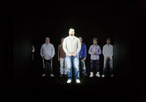 Still from art film with people in darkness
