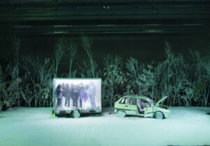 Snowy stage with a broken down car