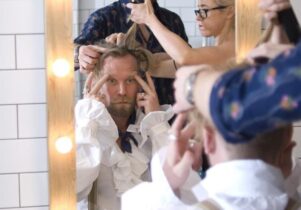 Comedian Tony Law being made up for the stage