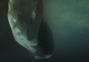 Photo of a woman sinking under water