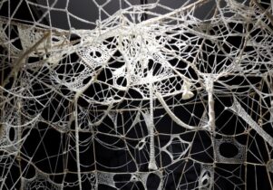 White crochet web in a black room