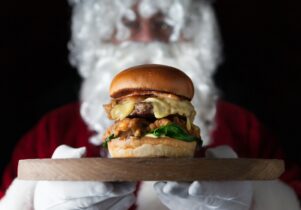 Santa holding a towering burger