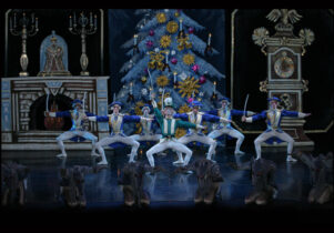 Soldiers dancing in front of a Christmas tree in The Nutcracker