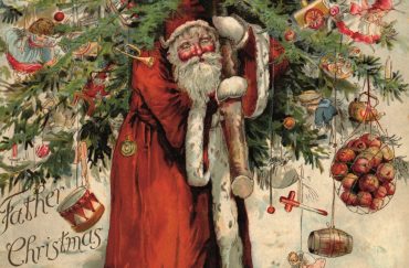 Santa carrying a decoration laden tree