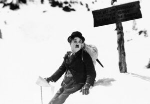 Black and white still of Charlie Chaplin in the snow
