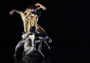 A column of dancers in gold