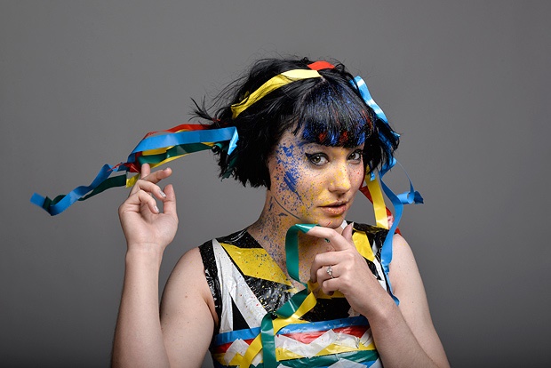 A woman covered in different coloured tape