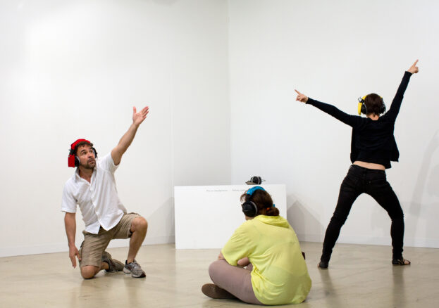 People gesturing in an exhibition