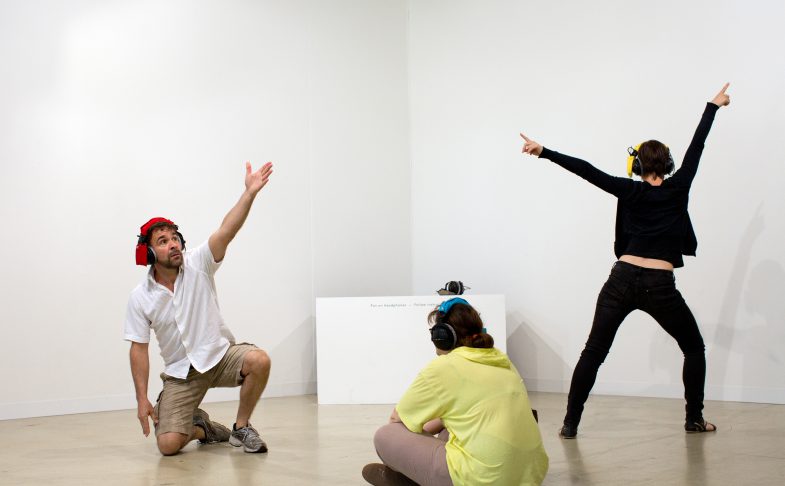 People gesturing in an exhibition
