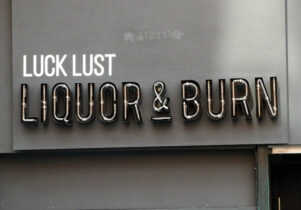 Image of the signage outside of Manchester's Luck Lust Liquor and Burn