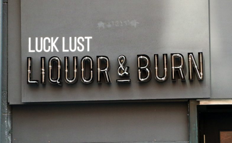 Image of the signage outside of Manchester's Luck Lust Liquor and Burn