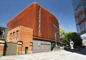 The Corten exterior of People’s History Museum on a sunny day beneath blue skies