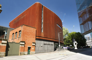 The Corten exterior of People’s History Museum on a sunny day beneath blue skies