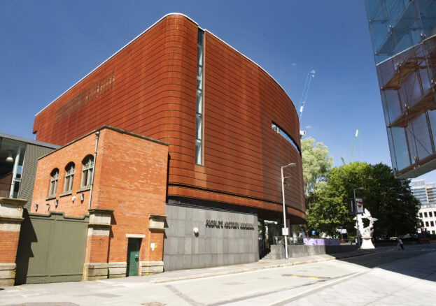 The Corten exterior of People’s History Museum on a sunny day beneath blue skies