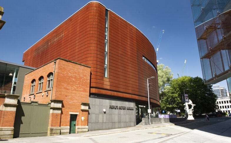 The Corten exterior of People’s History Museum on a sunny day beneath blue skies