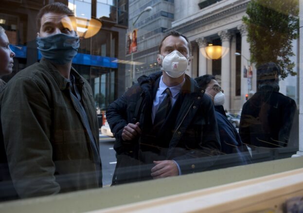 People on the street wearing anti-infection face masks .