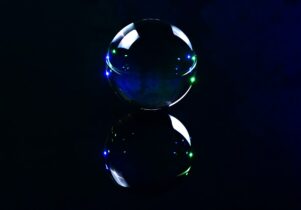 A glass witchball shown against a black background.