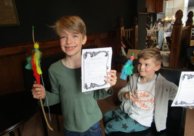 Grimm & Co event - two children shown holding crafts they've made