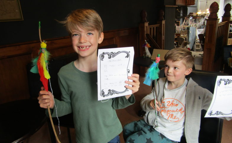 Grimm & Co event - two children shown holding crafts they've made