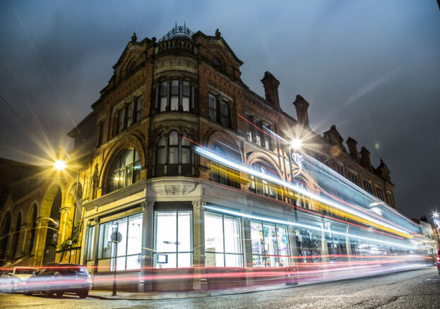 Building shown in evening with colourful blurred lights - for 3D printing architecture workshop