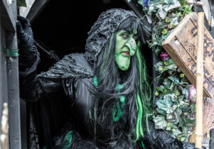 A witch in a door way. Part of Halloween in the City 2019.