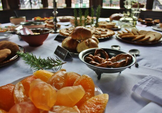 Table laid with Tudor festive treats as part of Yuletide event.