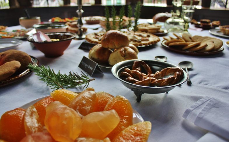 Table laid with Tudor festive treats as part of Yuletide event.