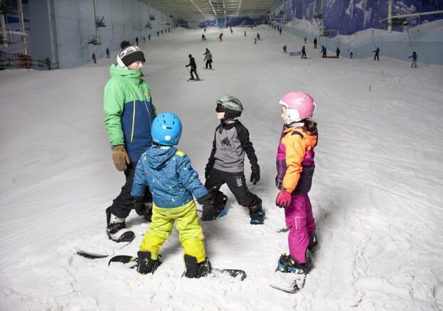 Three children with an instructor on the slope at Chill Factore