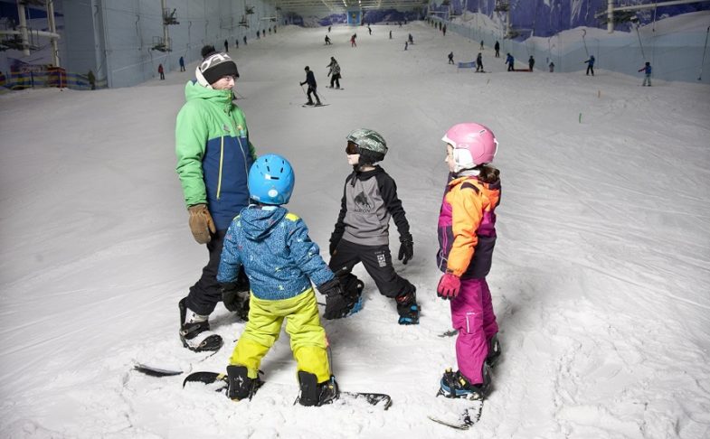 Three children with an instructor on the slope at Chill Factore