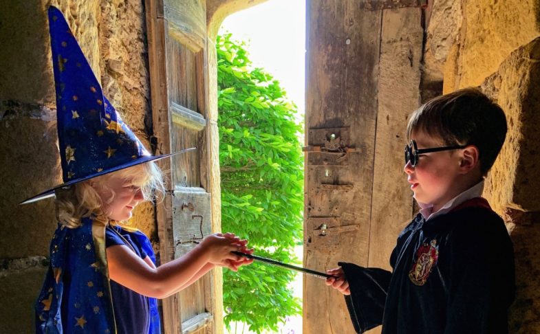 A boy and girl dressed in Halloween costume for the Little school of sorcery at Haddon Hall.