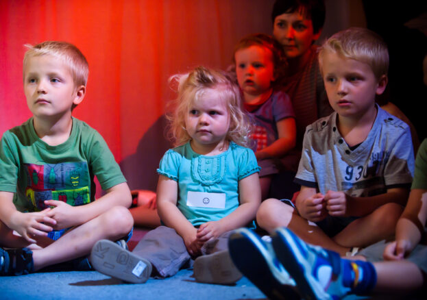 Children sat on the floor for Under the Rainbow activity