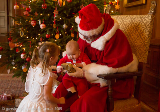 A baby on Santa's knew, part of An afternoon audience with Father Christmas