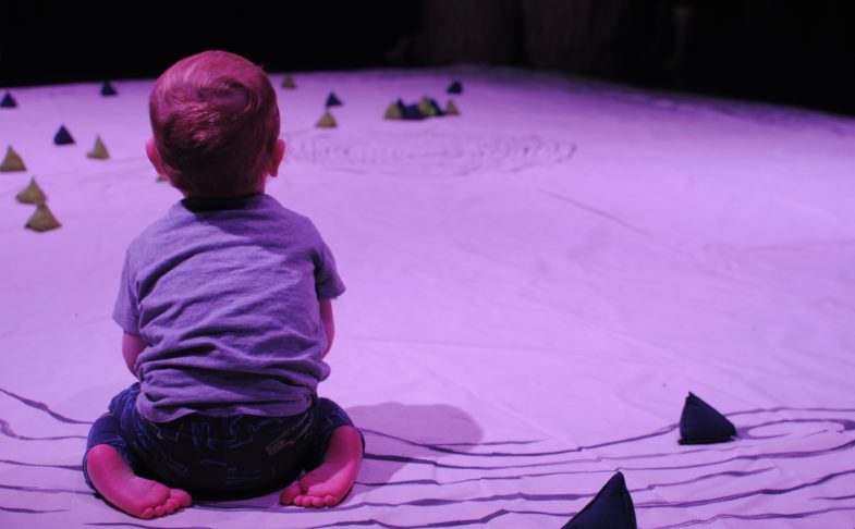 Child sat on the floor in Meet Me A Tree