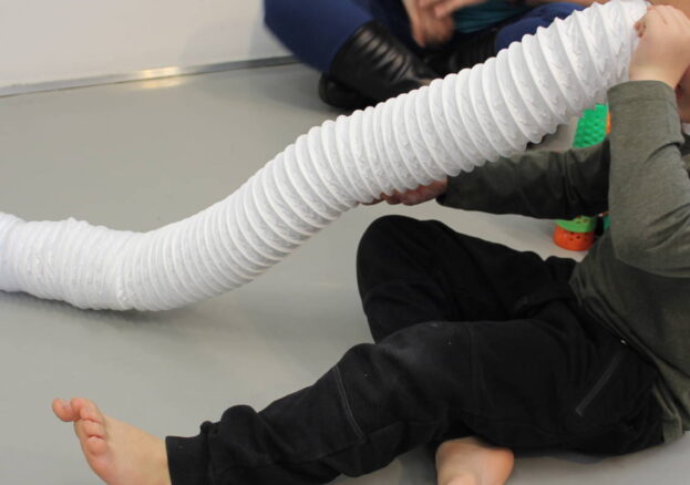 Boy playing with a tube in the SEND friendly sessions