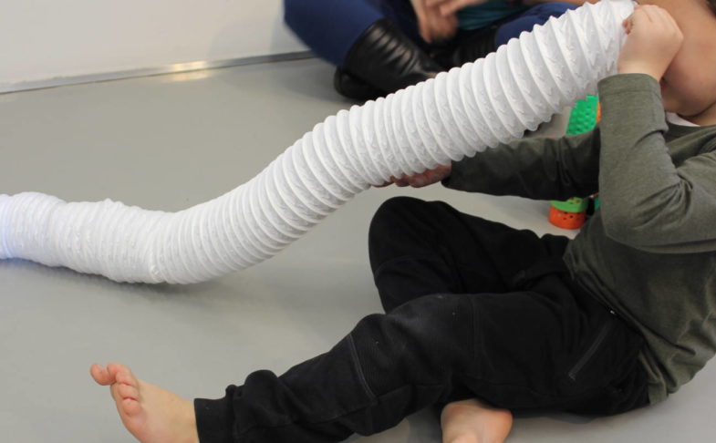 Boy playing with a tube in the SEND friendly sessions