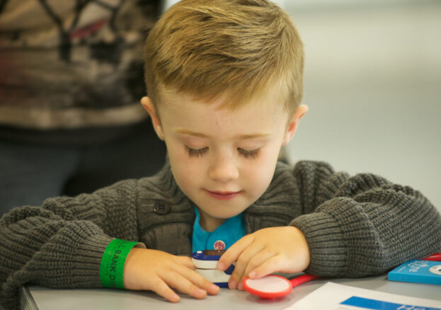 Little boy making something at the space crafts event