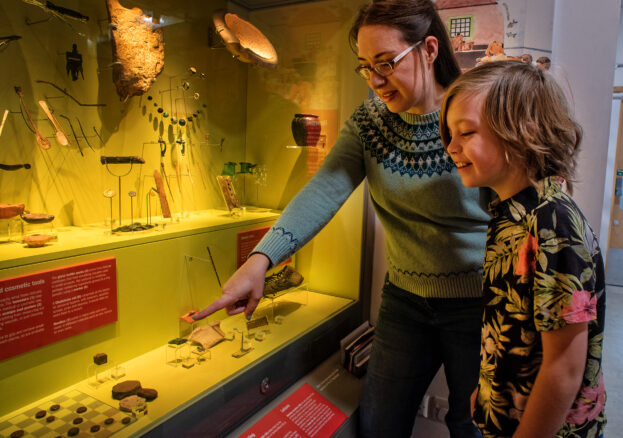 Adult and child looking at part of the collections