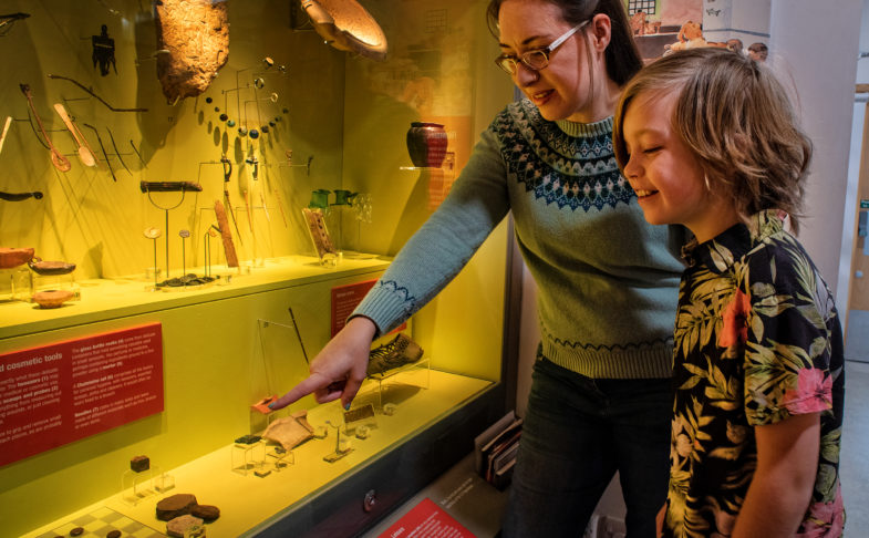 Adult and child looking at part of the collections