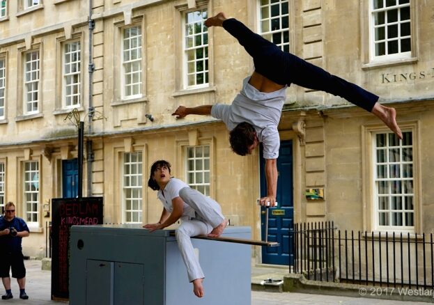 An performer doing acrobatics on a box