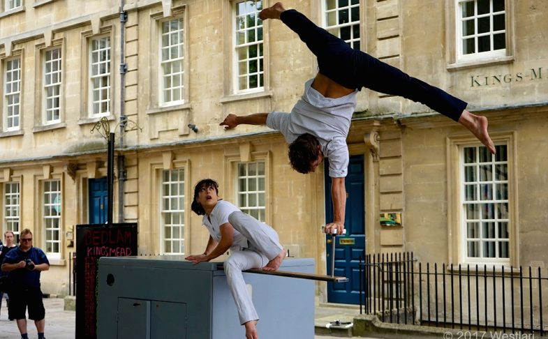 An performer doing acrobatics on a box