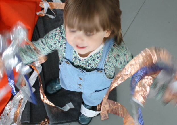 young girl playing with material in a mindful makers session
