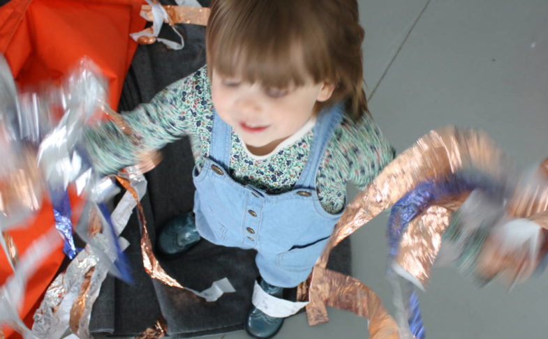 young girl playing with material in a mindful makers session