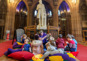 Children sat on cushions in Toddler Tales session