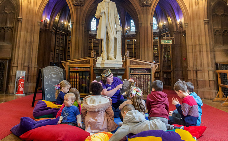 Children sat on cushions in Toddler Tales session