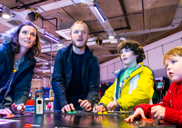 A family enjoying gaming together at the National Videogame Museum.