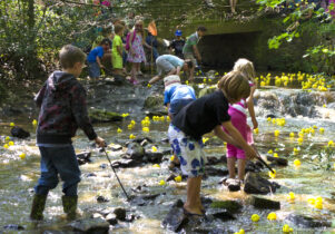 Children enjoy the annual Great Sheffield Duck Race in Endcliffe Park, Sheffield.